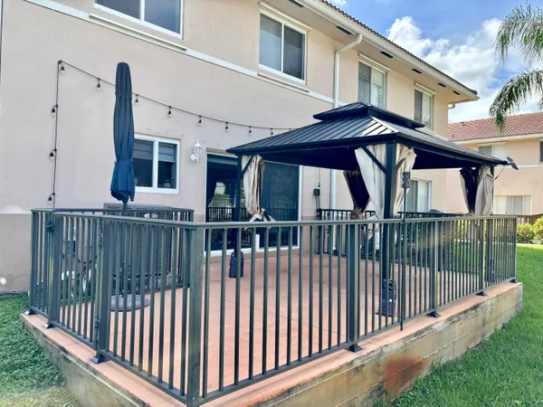 a view of a house with iron fence
