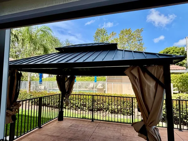 a view of balcony with wooden floor and outdoor seating