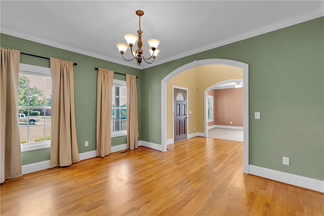 406 Hopewell Ridge Anderson, SC 29621 - Photo 6 of 46 This inviting space features hardwood flooring, elegant crown molding, and an arched entryway.