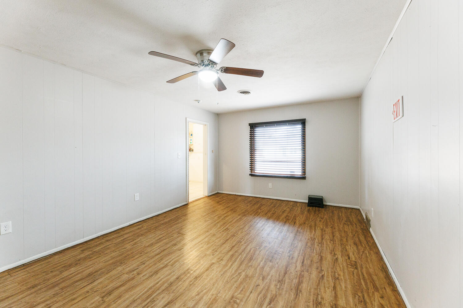 3501 26th Street Lubbock, TX 79410 - Photo 18 of 36 an empty room with wooden floor fan and windows