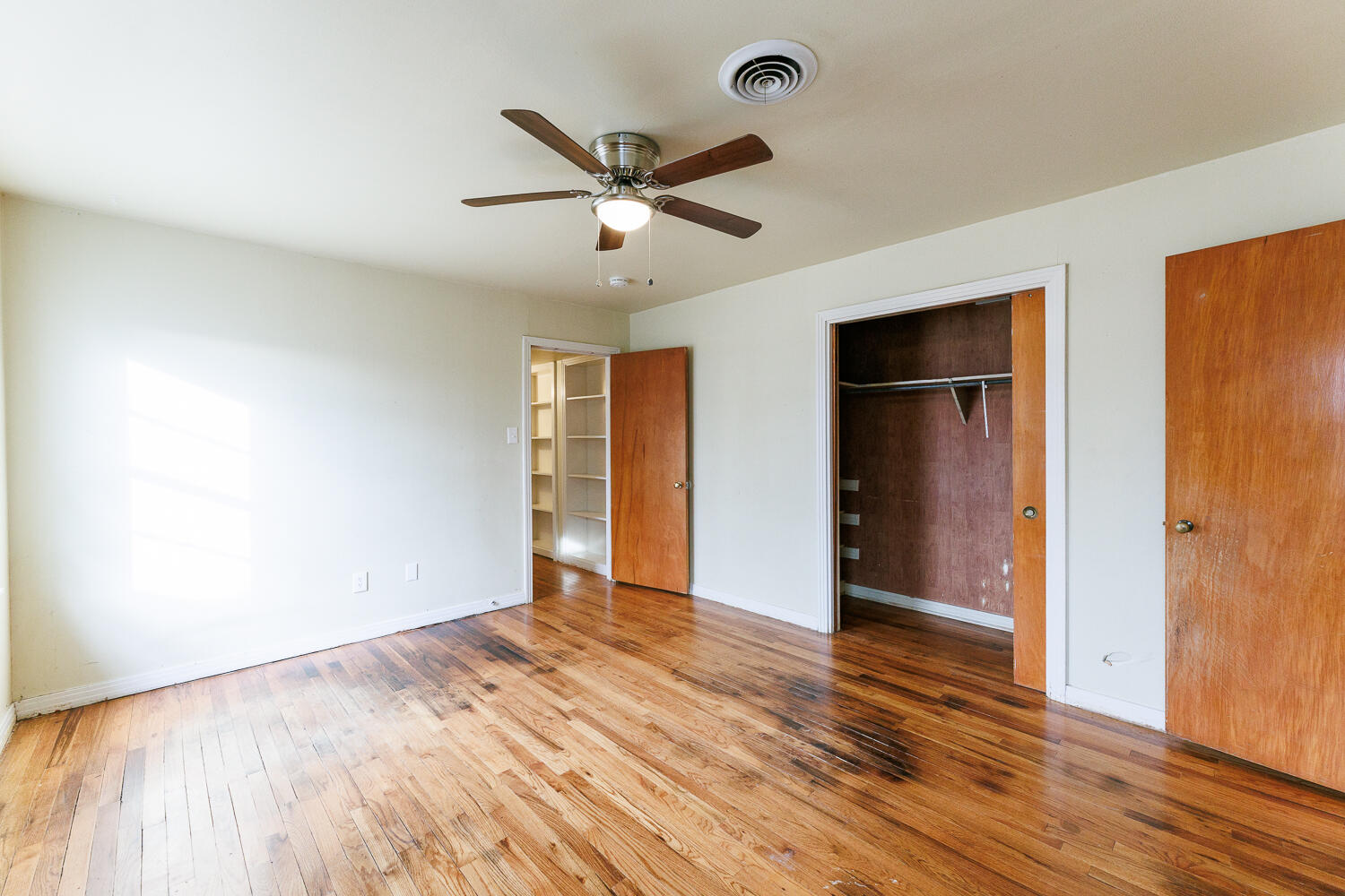 3501 26th Street Lubbock, TX 79410 - Photo 21 of 36 an empty room with wooden floor closet and windows