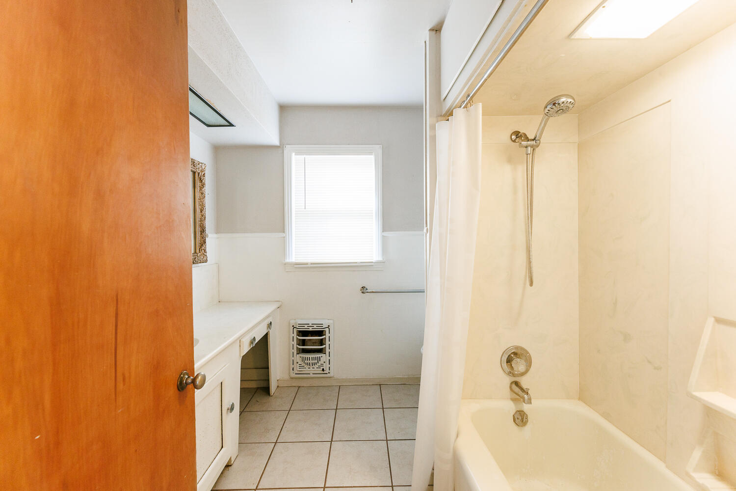 3501 26th Street Lubbock, TX 79410 - Photo 22 of 36 a bathroom with a bathtub a shower a sink and a toilet