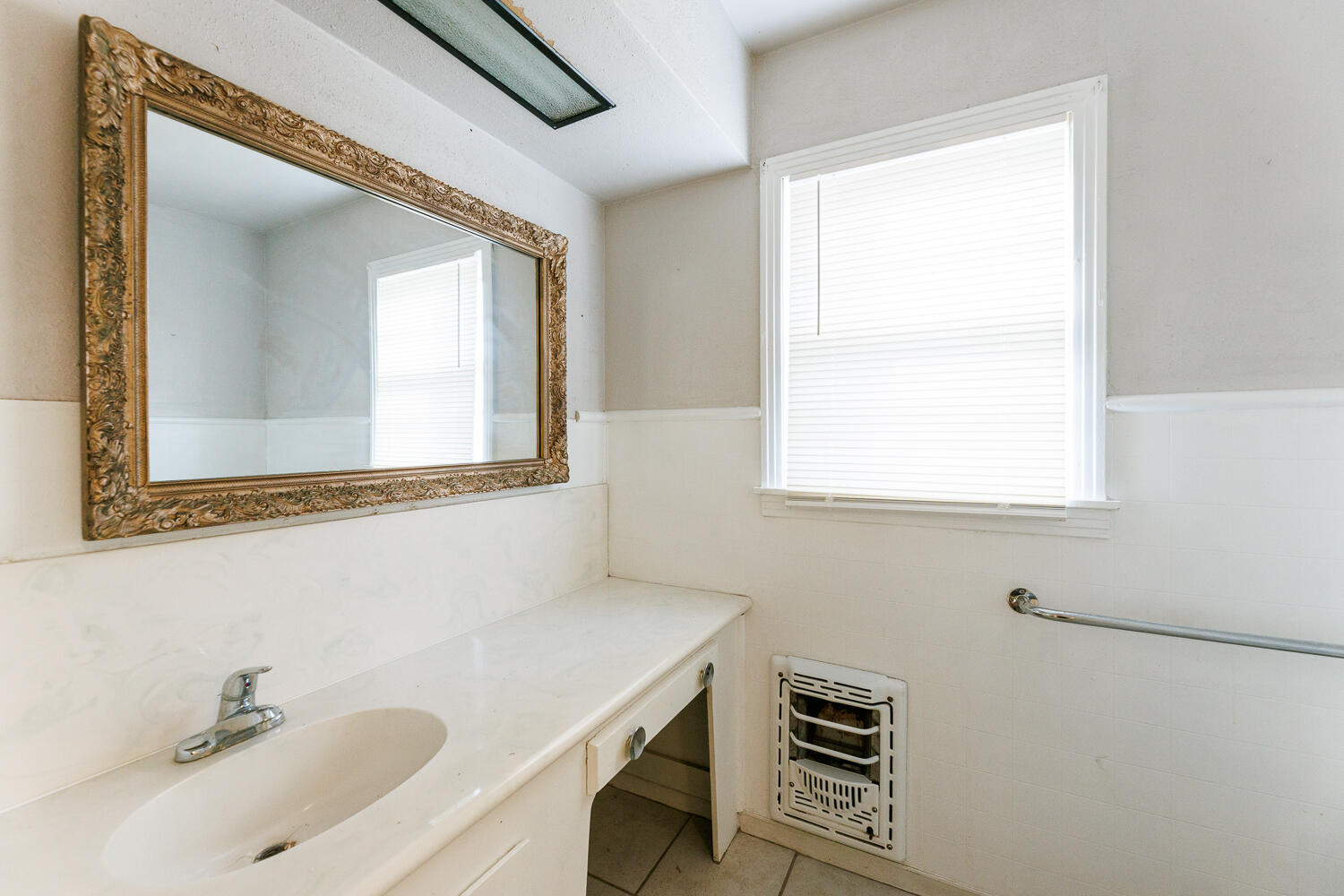 3501 26th Street Lubbock, TX 79410 - Photo 23 of 36 a bathroom with a sink and a mirror