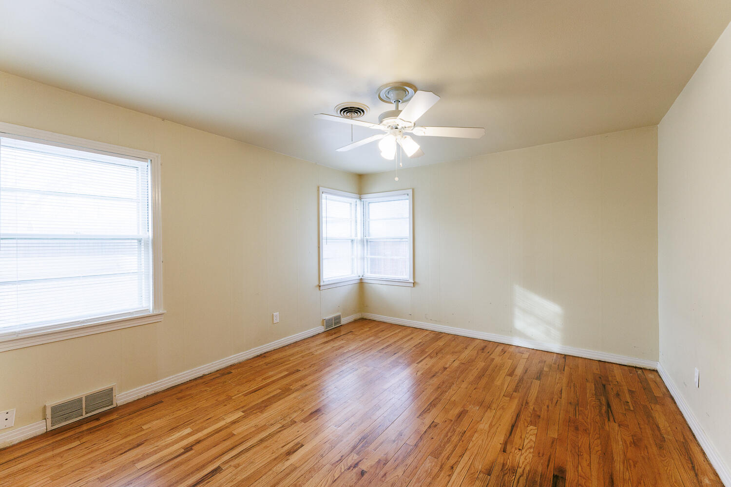 3501 26th Street Lubbock, TX 79410 - Photo 25 of 36 a view of an empty room with wooden floor and a window