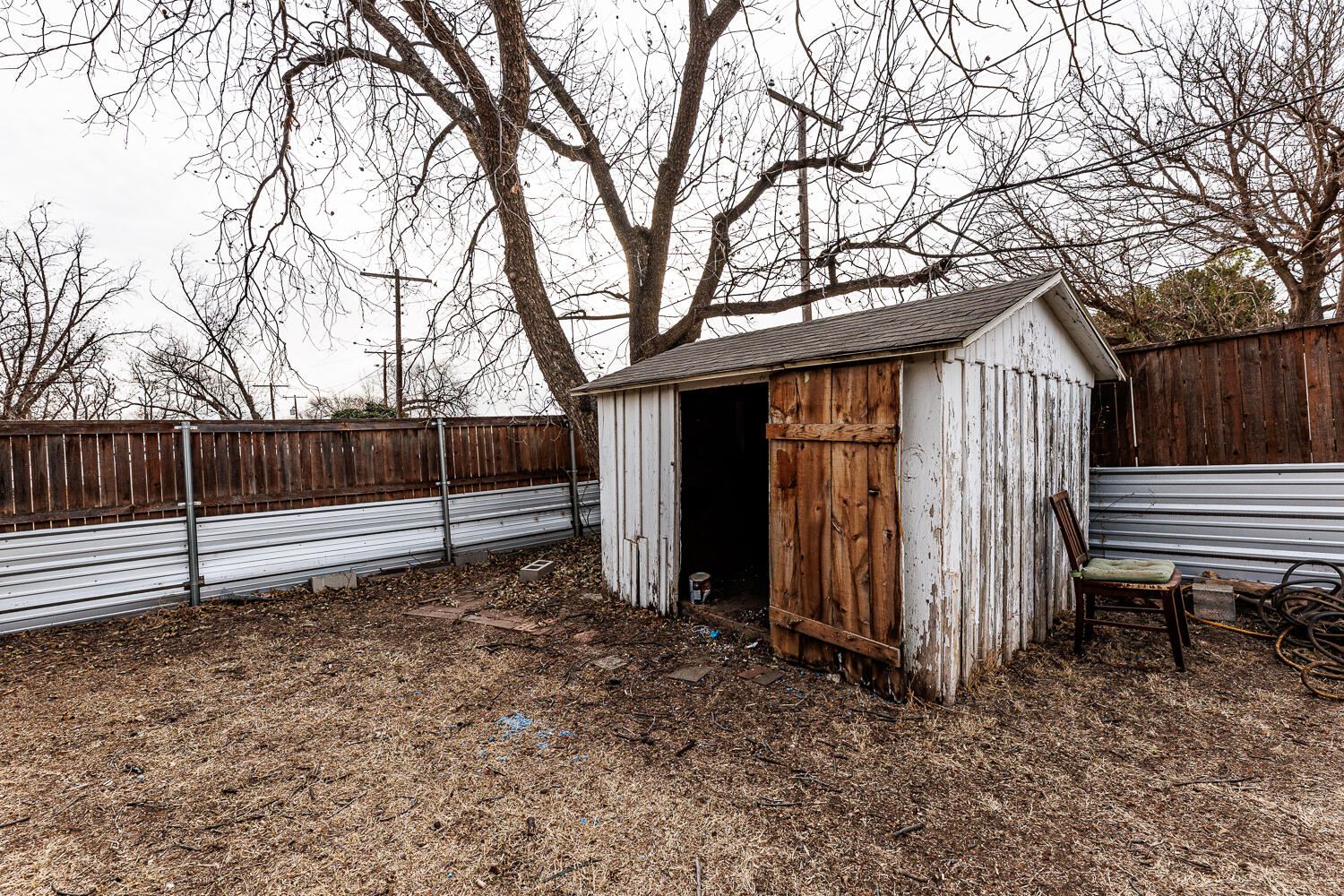 3501 26th Street Lubbock, TX 79410 - Photo 32 of 36 a backyard of a house with wooden fence and large trees