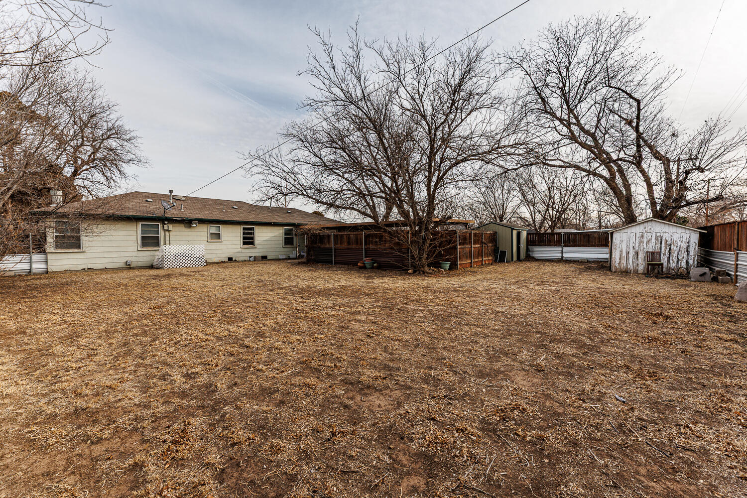 3501 26th Street Lubbock, TX 79410 - Photo 33 of 36 a front view of a house with a yard covered in snow