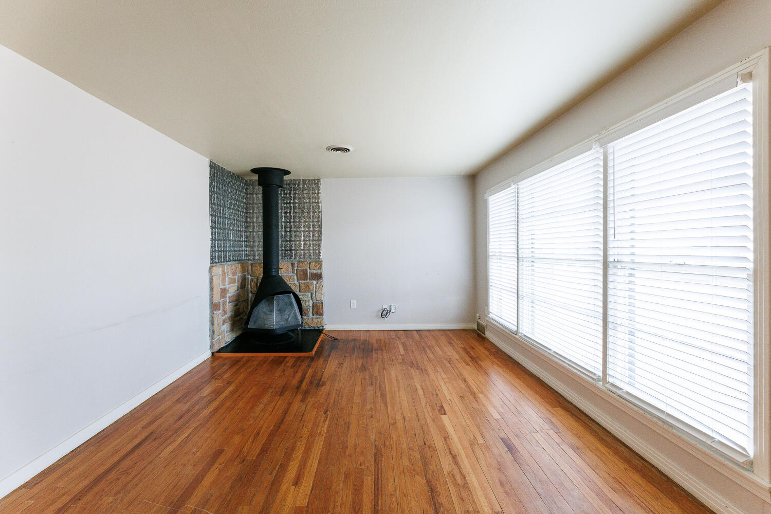 3501 26th Street Lubbock, TX 79410 - Photo 4 of 36 a view of empty room with wooden floor and fan