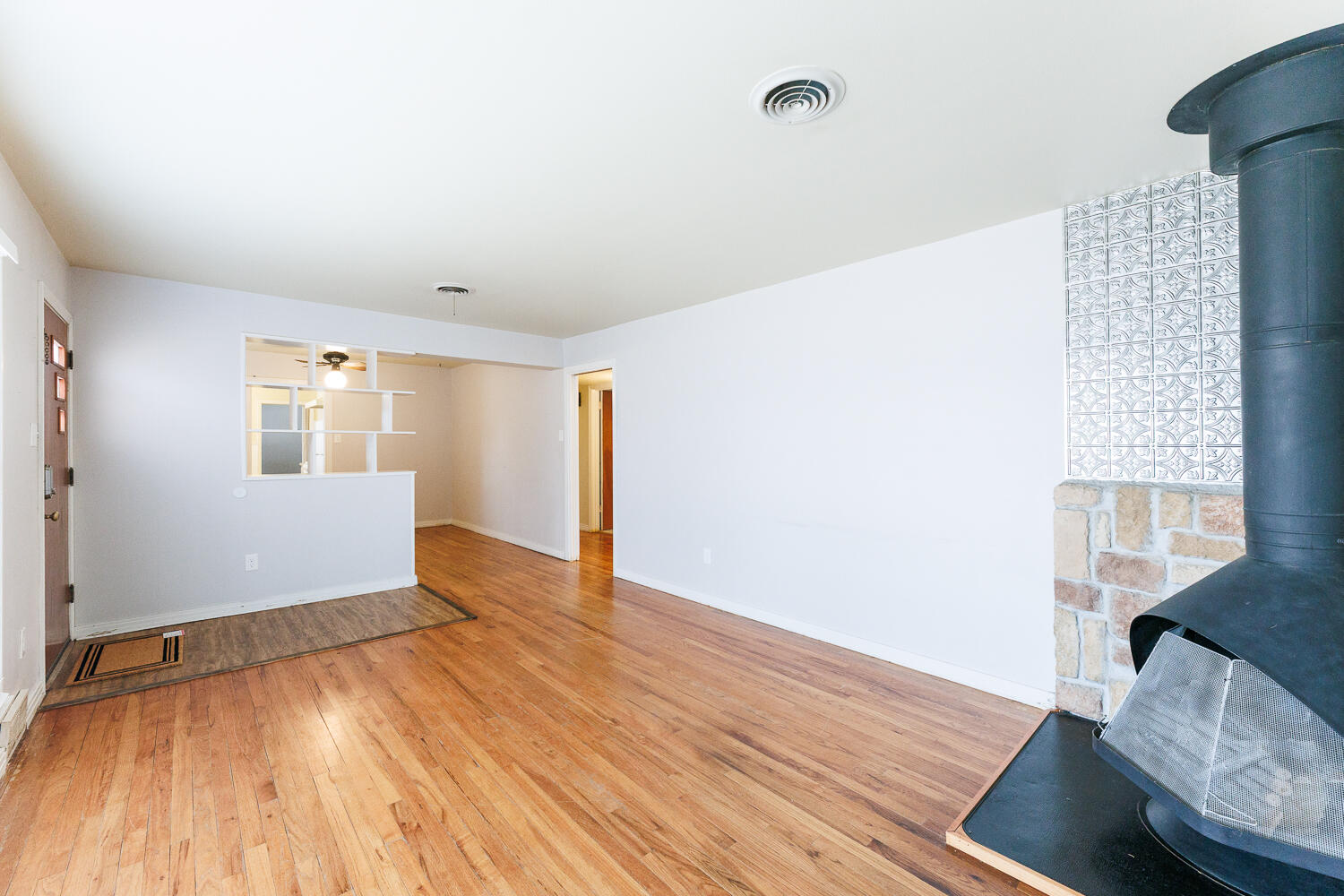 3501 26th Street Lubbock, TX 79410 - Photo 6 of 36 an empty room with wooden floor and windows