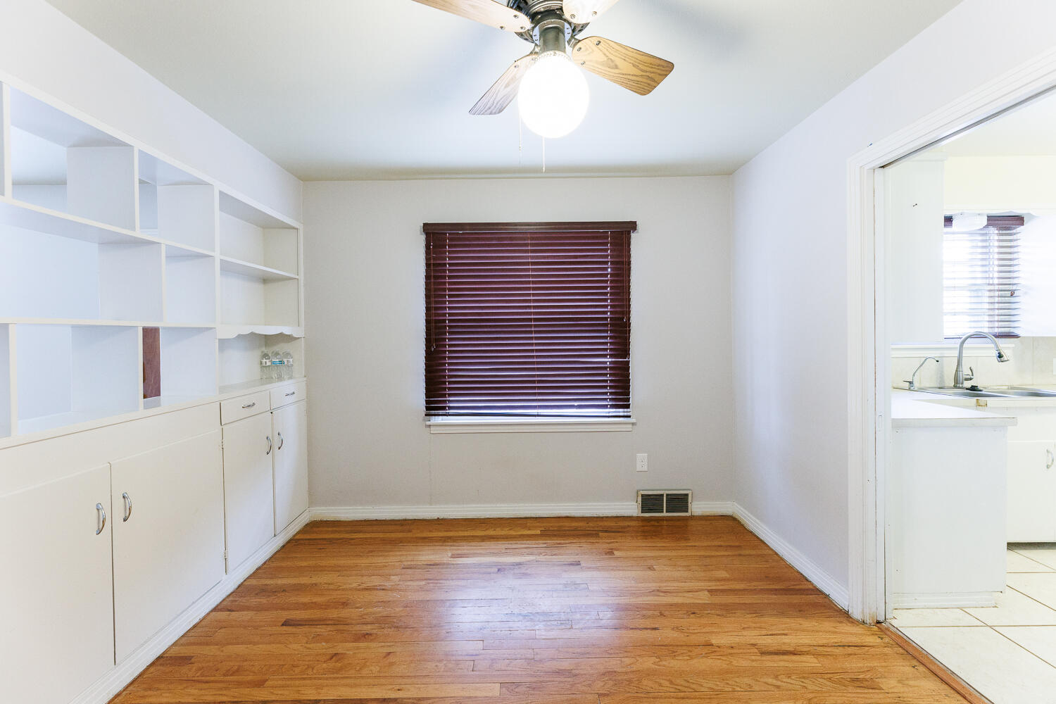 3501 26th Street Lubbock, TX 79410 - Photo 8 of 36 a view of an empty room with a window and wooden floor