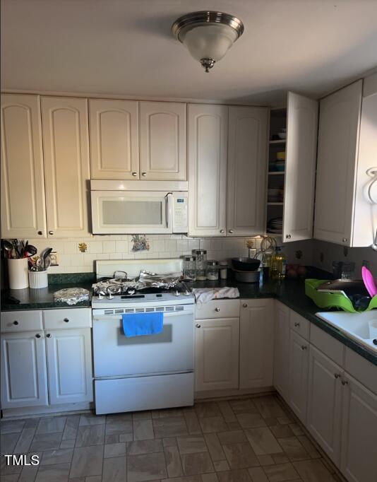 4001 Pickwick Drive Raleigh, NC 27613 - Photo 3 of 5 a kitchen with a sink stove and cabinets