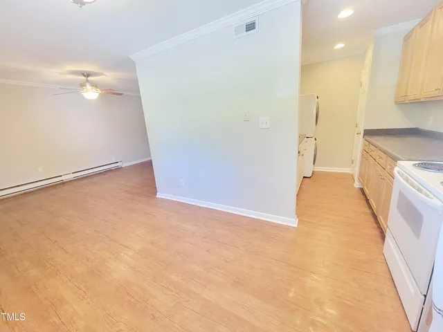 a large white kitchen with granite countertop a sink