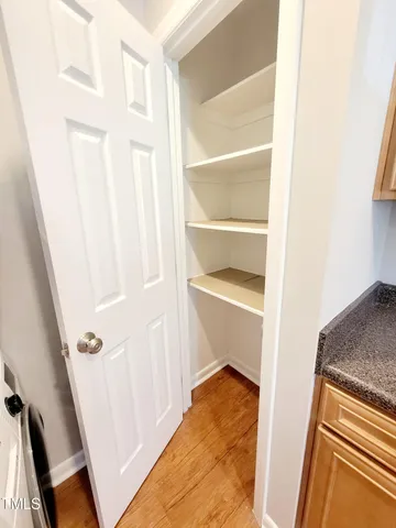 a view of a room with wooden floor and windows