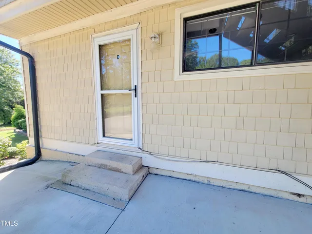 an aerial view of residential house with outdoor space and trees all around