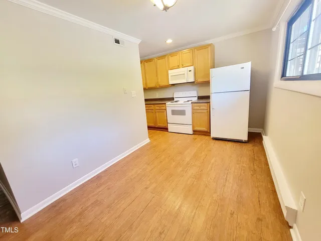 a view of a kitchen with a stove top oven a refrigerator and a stove