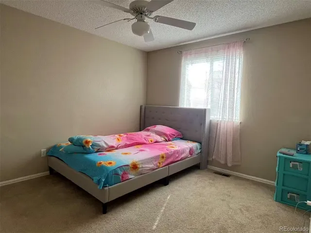 a bed room with a bed and a window