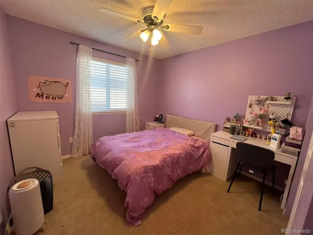 a bedroom with a bed and a desk