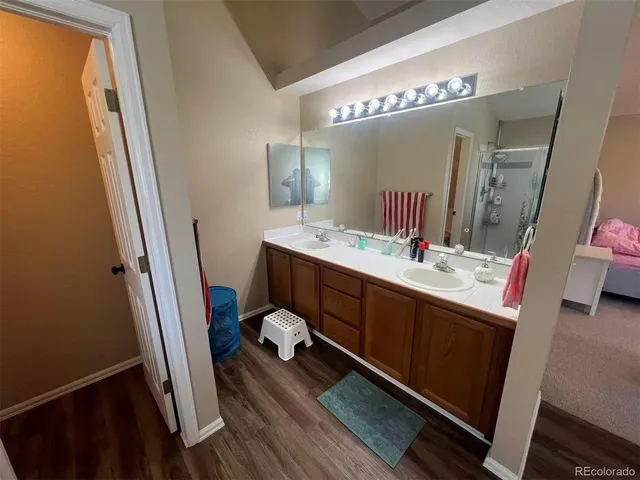 a bathroom with a double vanity sink and a mirror