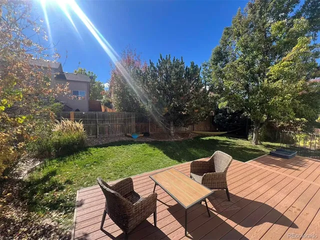 a view of a backyard with sitting area
