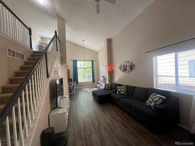 a living room with furniture and a hard wood floor