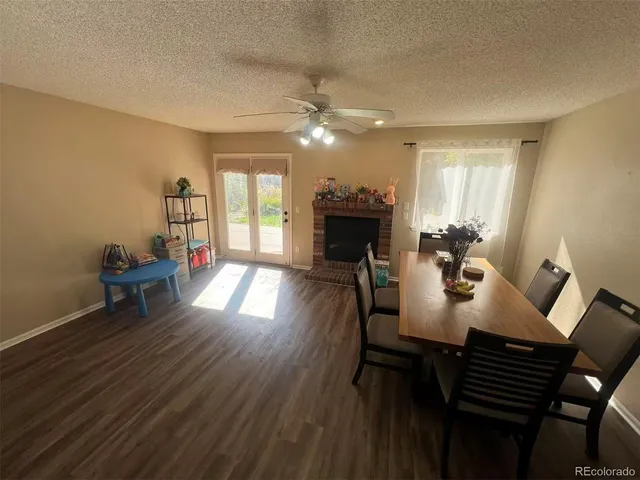 a dining room with furniture and wooden floor