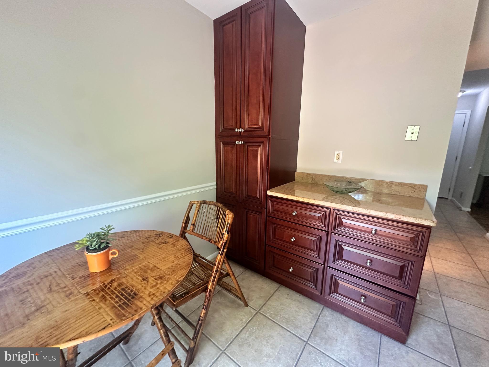 9705 Glen Avenue Silver Spring, MD 20910 - Photo 10 of 43 a room with a chair and a potted plant