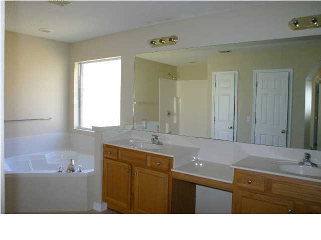 4481 Antioch Road Crestview, FL 32536 - Photo 13 of 21 a bathroom with a sink double vanity granite tub shower and a mirror