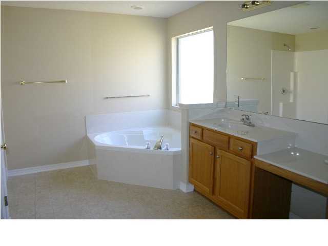 4481 Antioch Road Crestview, FL 32536 - Photo 14 of 21 a bathroom with a sink a bathtub and mirror
