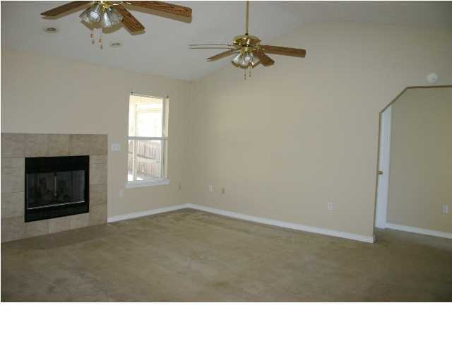 4481 Antioch Road Crestview, FL 32536 - Photo 3 of 21 a room with a fireplace and a chandelier fan