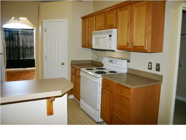 4481 Antioch Road Crestview, FL 32536 - Photo 5 of 21 a kitchen with stainless steel appliances a stove a refrigerator a sink and cabinets