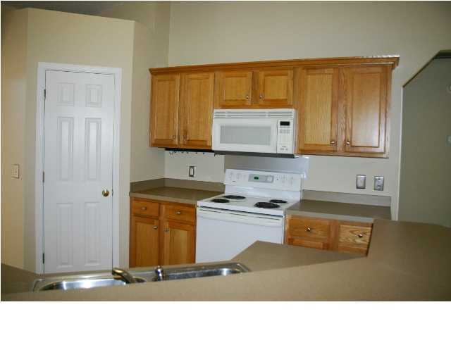 4481 Antioch Road Crestview, FL 32536 - Photo 6 of 21 a kitchen with a stove a sink and a microwave