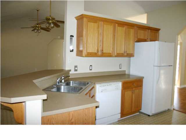 4481 Antioch Road Crestview, FL 32536 - Photo 7 of 21 a kitchen with a sink a refrigerator and a sink