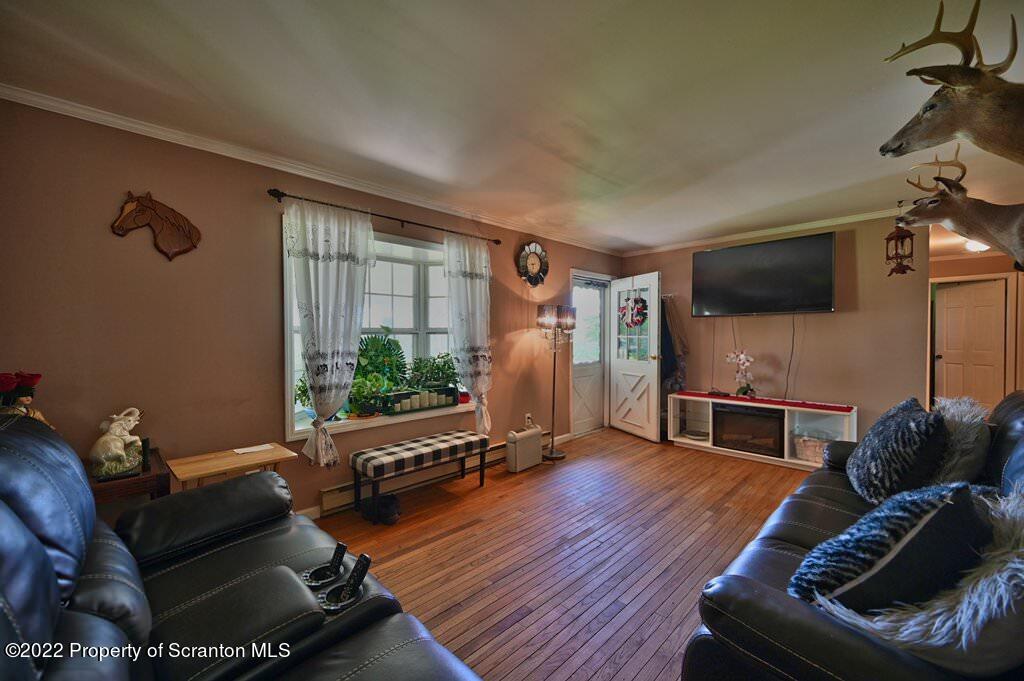 217 Hemlock Road Lake Ariel, PA 18436 - Photo 12 of 54 a living room with furniture gym equipment and a flat screen tv