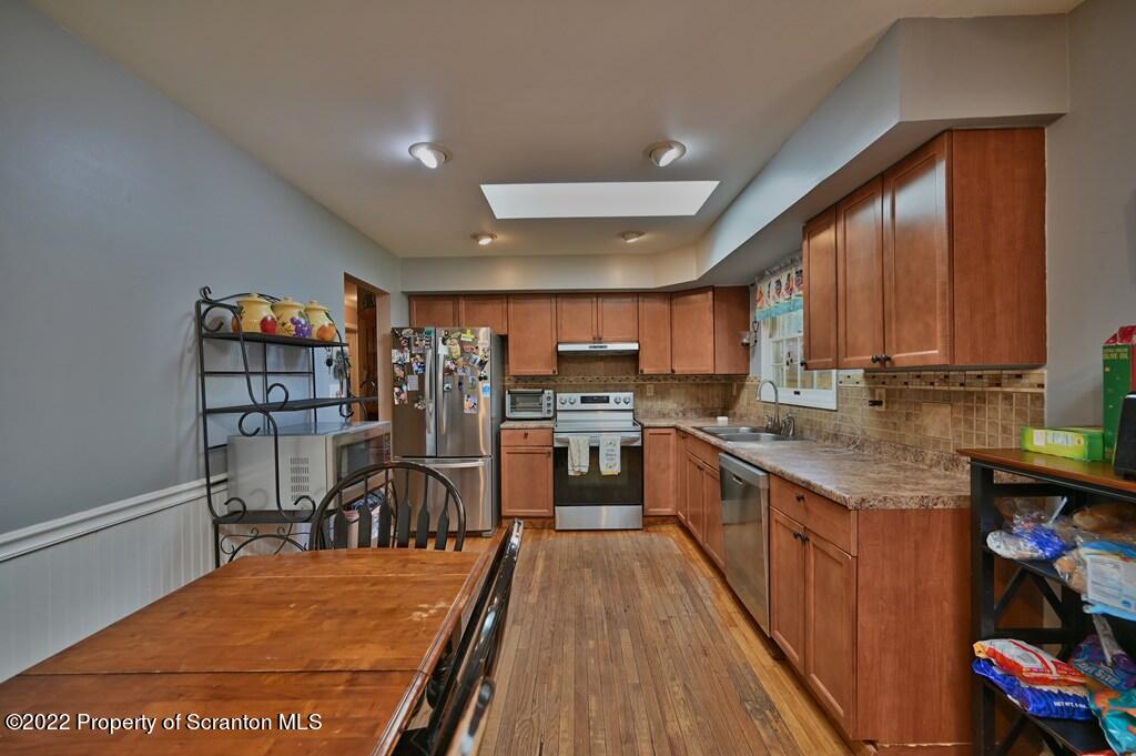 217 Hemlock Road Lake Ariel, PA 18436 - Photo 18 of 54 a kitchen with stainless steel appliances granite countertop lots of counter top space and wooden floor