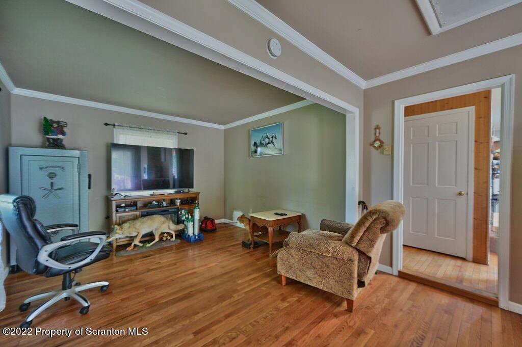 217 Hemlock Road Lake Ariel, PA 18436 - Photo 26 of 54 a living room with furniture a flat screen tv and gym equipment