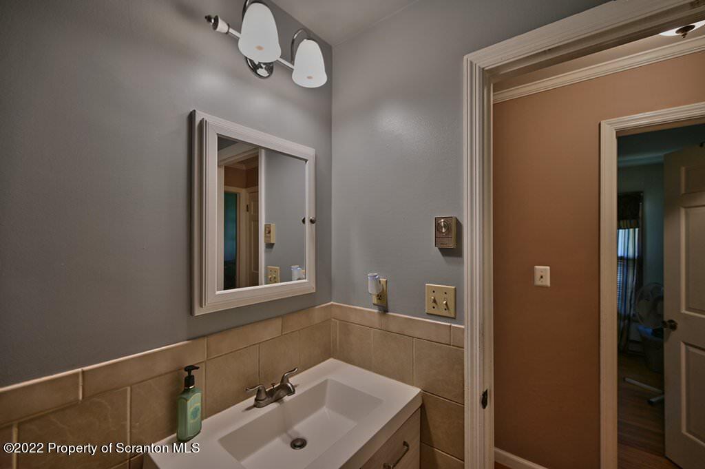 217 Hemlock Road Lake Ariel, PA 18436 - Photo 36 of 54 a bathroom with a sink a mirror and vanity
