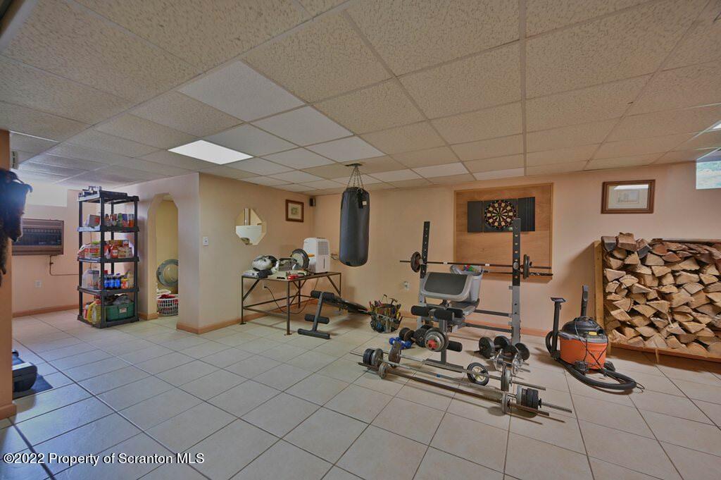 217 Hemlock Road Lake Ariel, PA 18436 - Photo 39 of 54 a living room with lots of furniture and gym equipment