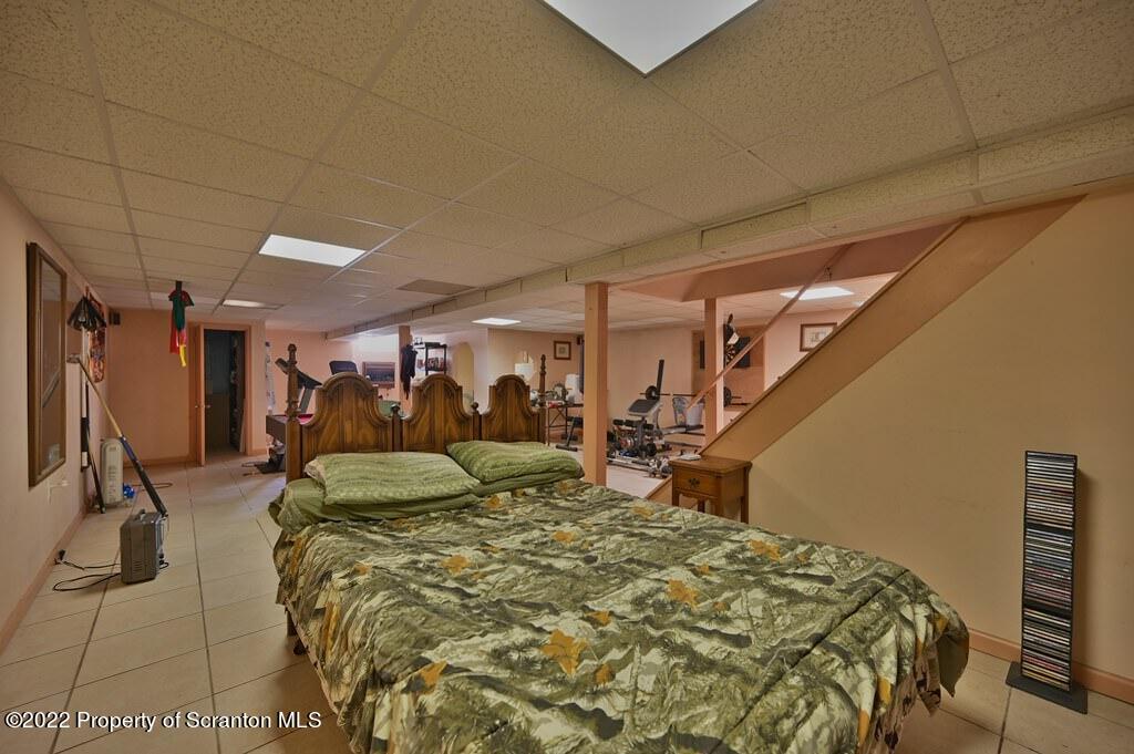 217 Hemlock Road Lake Ariel, PA 18436 - Photo 41 of 54 a bed sitting in a room next to a lamp