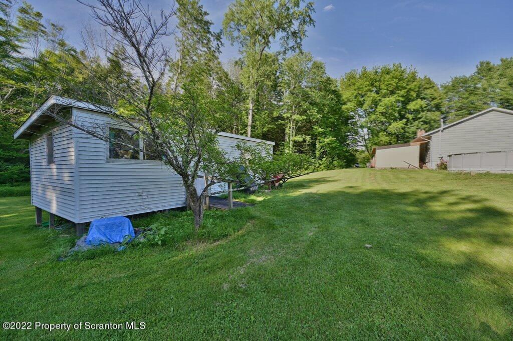 217 Hemlock Road Lake Ariel, PA 18436 - Photo 45 of 54 a view of a backyard with wooden fence and a bench