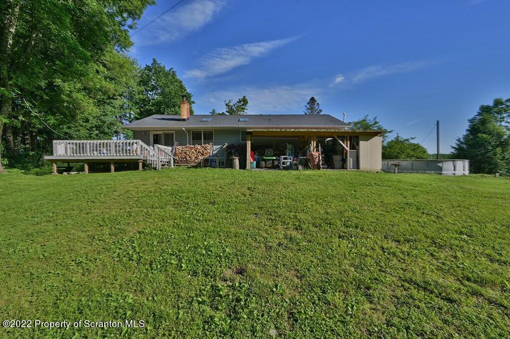 217 Hemlock Road Lake Ariel, PA 18436 - Photo 6 of 54 a view of a house with a big yard and large trees