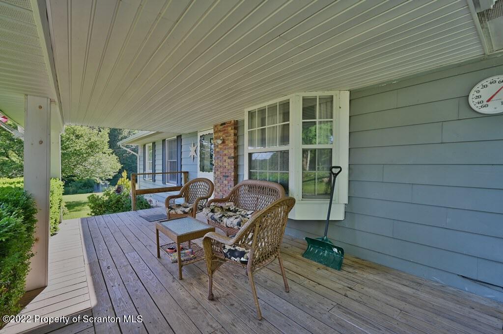 217 Hemlock Road Lake Ariel, PA 18436 - Photo 8 of 54 a view of a deck with table and chairs with wooden floor and fence