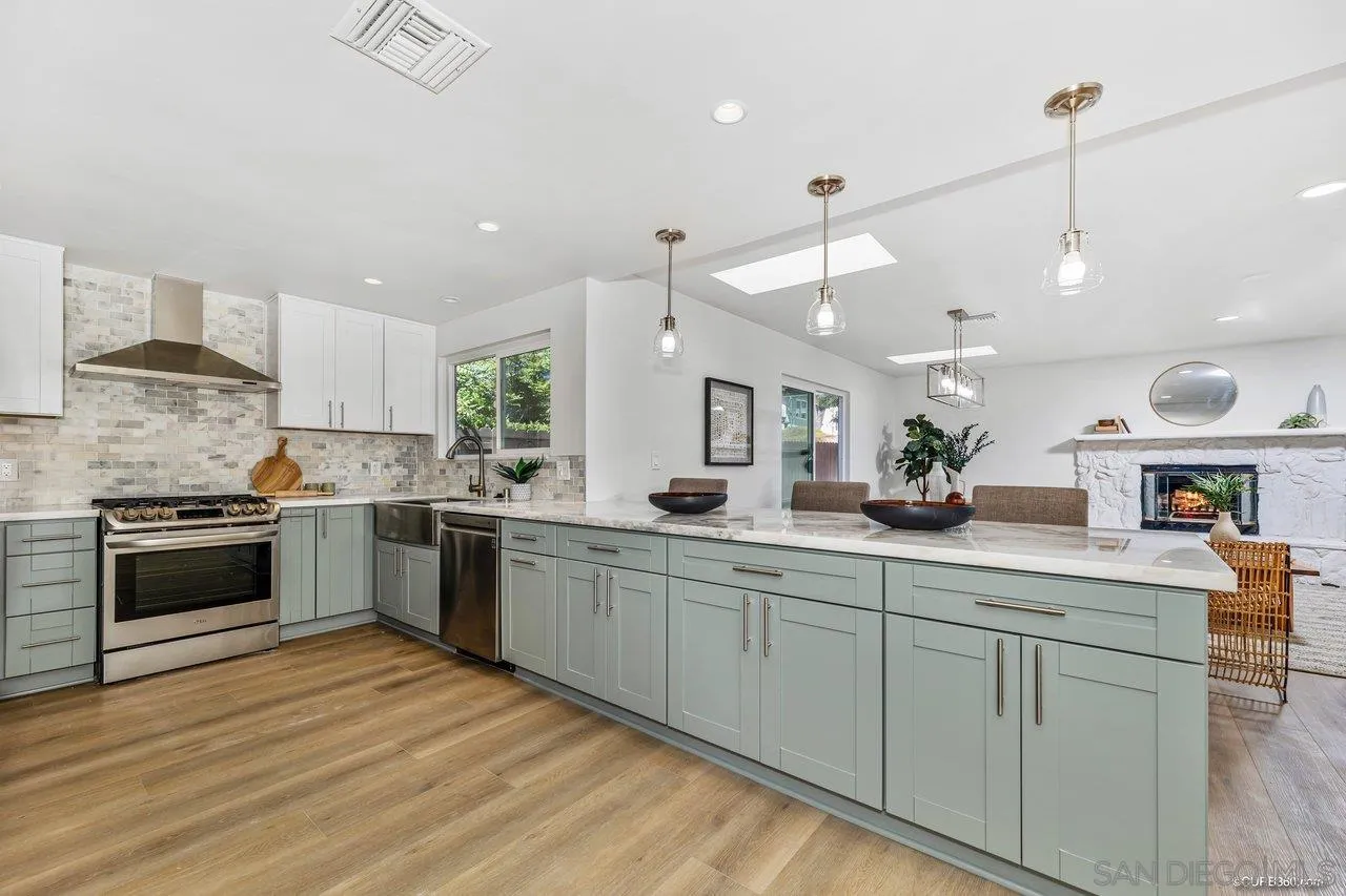12625 McFeron Road Poway, CA 92064 - Photo 4 of 37 a large white kitchen with a stove a sink dishwasher and a refrigerator
