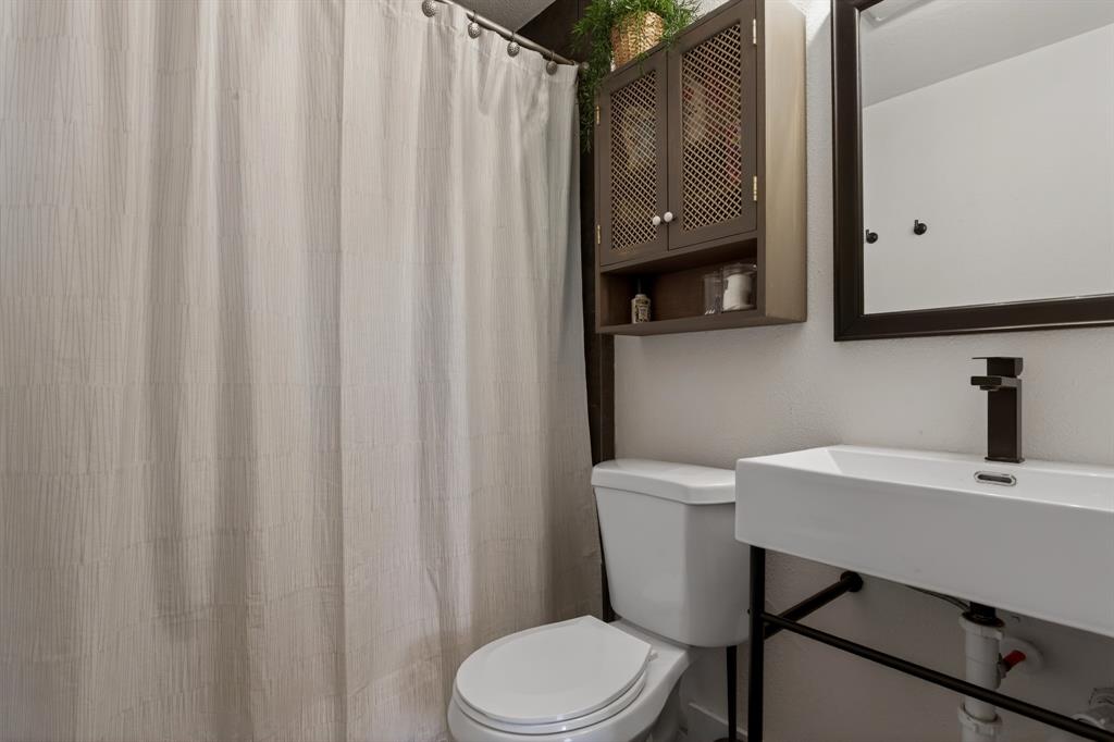 316 Old Justin Road Argyle, TX 76226 - Photo 27 of 40 One of the home’s special features is the incredibly rare Mother-In-Law retreat, offering a separate front entrance, garage & laundry access, equipped kitchen, living-dining area, bed, & full bath- an ideal haven for multi-gen living, long-term guests or income-producing opportunities.