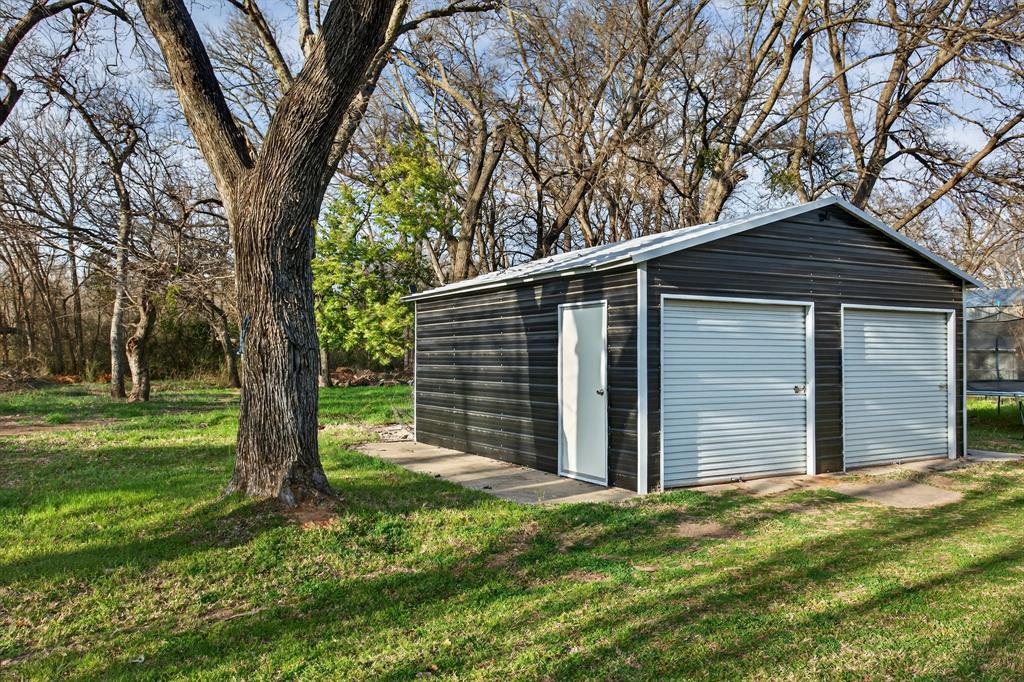 316 Old Justin Road Argyle, TX 76226 - Photo 35 of 40 Outside, the 20×20 metal shop (also added in 2021) invites creativity & hobbies, while the expansive lot offers endless possibilities with peaceful evenings under the Texas sunset sky.