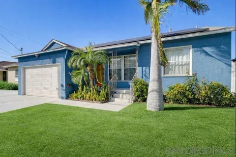 a view of a house with potted plants and a yard