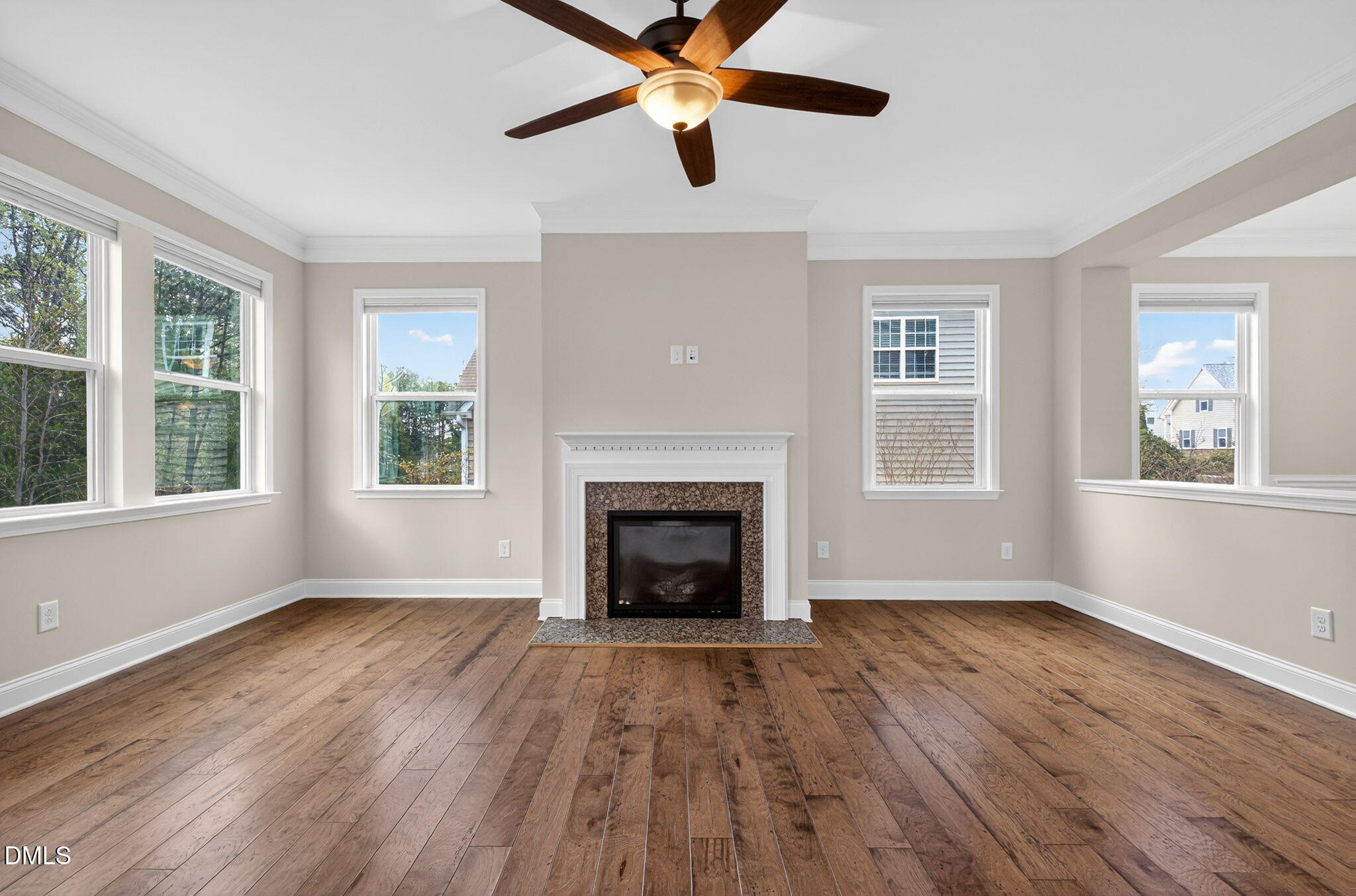 1304 Barnford Mill Road Wake Forest, NC 27587 - Photo 19 of 44 a view of an empty room with wooden floor fireplace and a window
