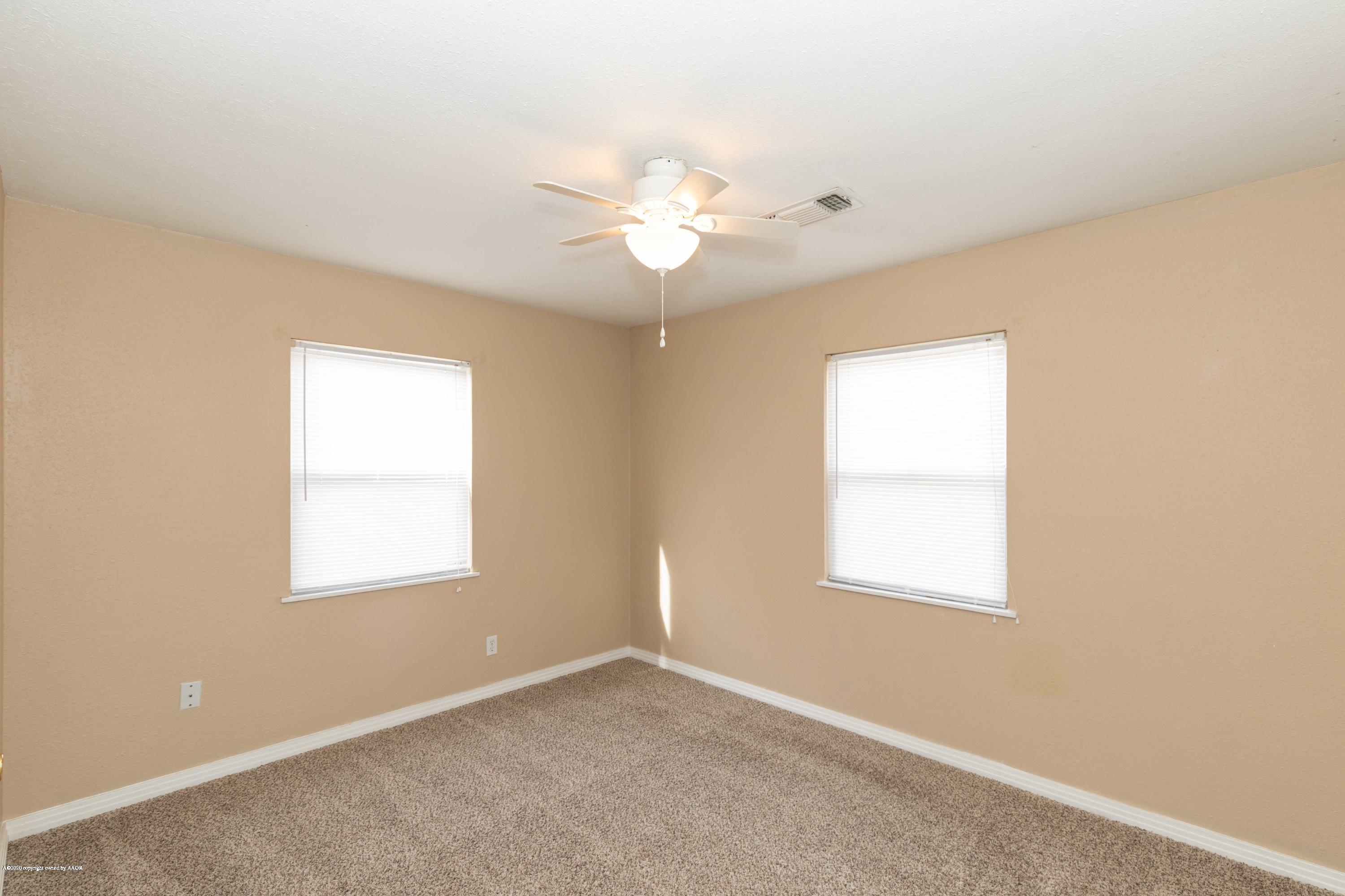 4361 South Tyler Street Amarillo, TX 79110 - Photo 18 of 30 an empty room with a window and a fan