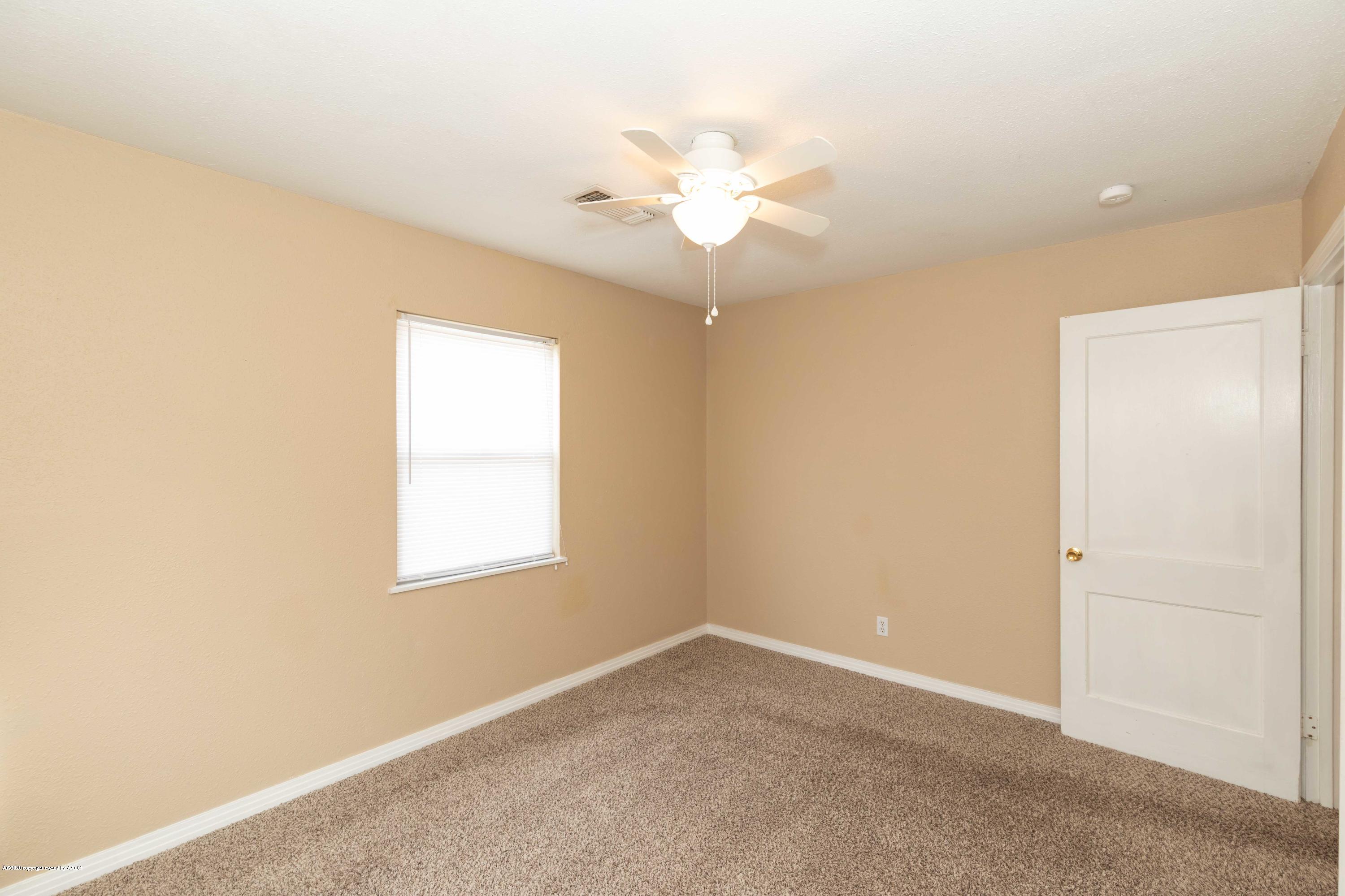 4361 South Tyler Street Amarillo, TX 79110 - Photo 21 of 30 an empty room with a chandelier fan and windows