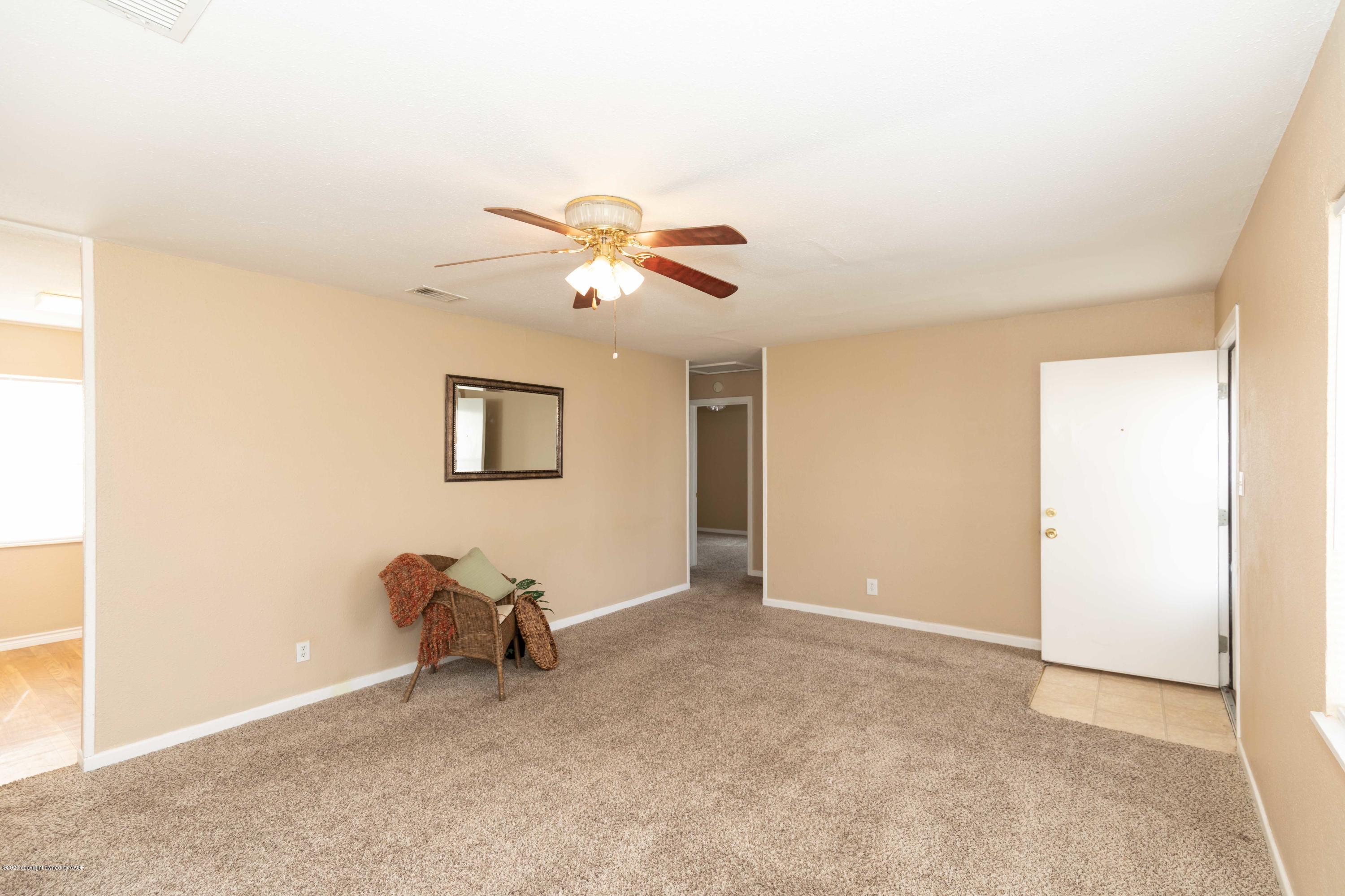 4361 South Tyler Street Amarillo, TX 79110 - Photo 7 of 30 a view of a room with a ceiling fan and a window