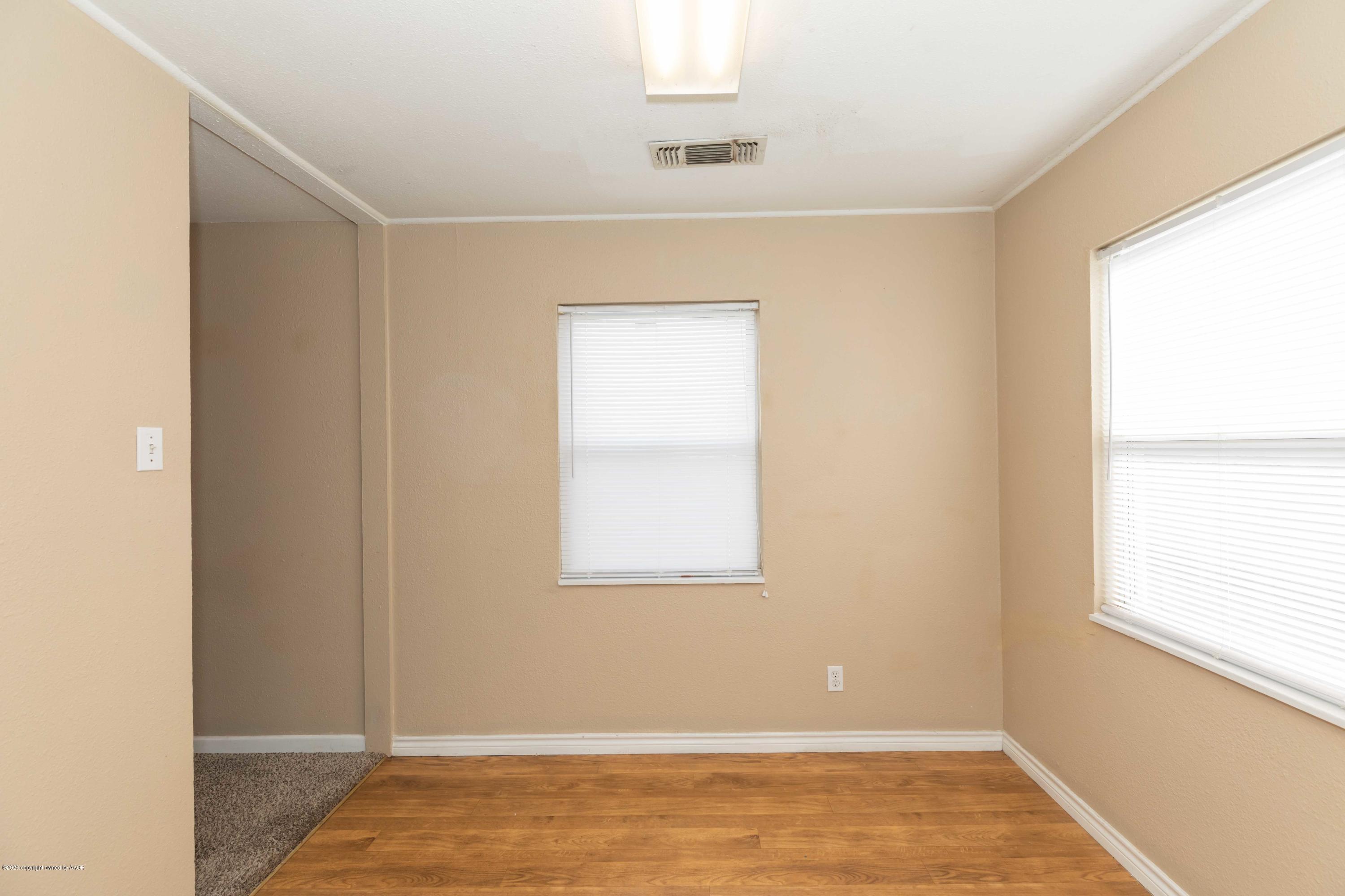 4361 South Tyler Street Amarillo, TX 79110 - Photo 8 of 30 a view of an empty room with wooden floor and a window
