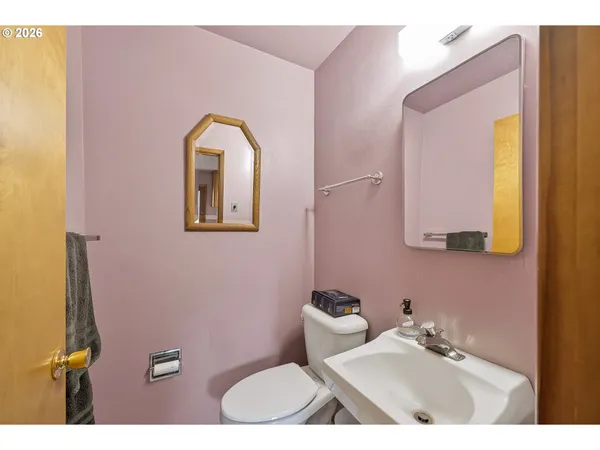 a bathroom with a toilet sink and mirror